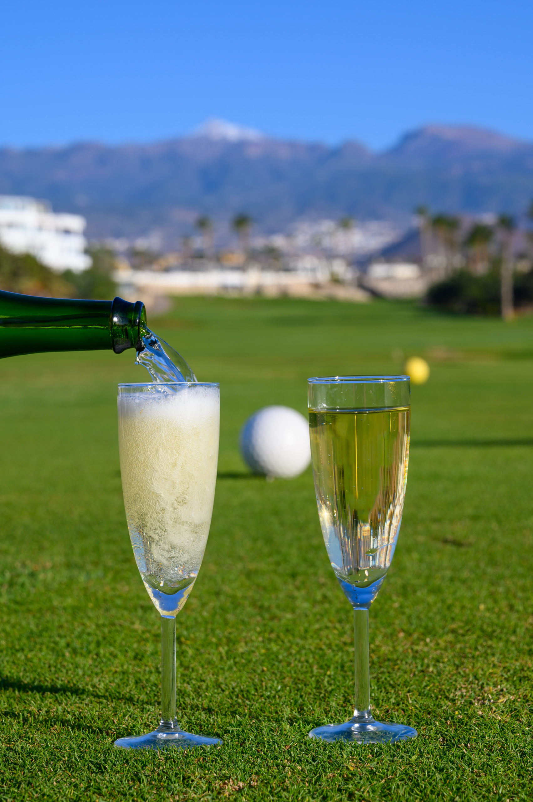 Two glasses with bubbles white champagne or cava wine served on